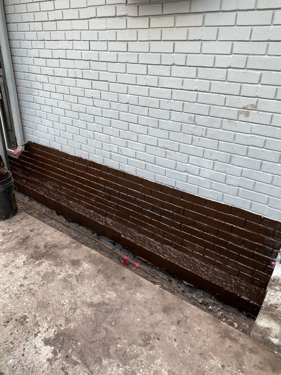 Foundation Sealer For Proper Waterproofing On White Brick Wall