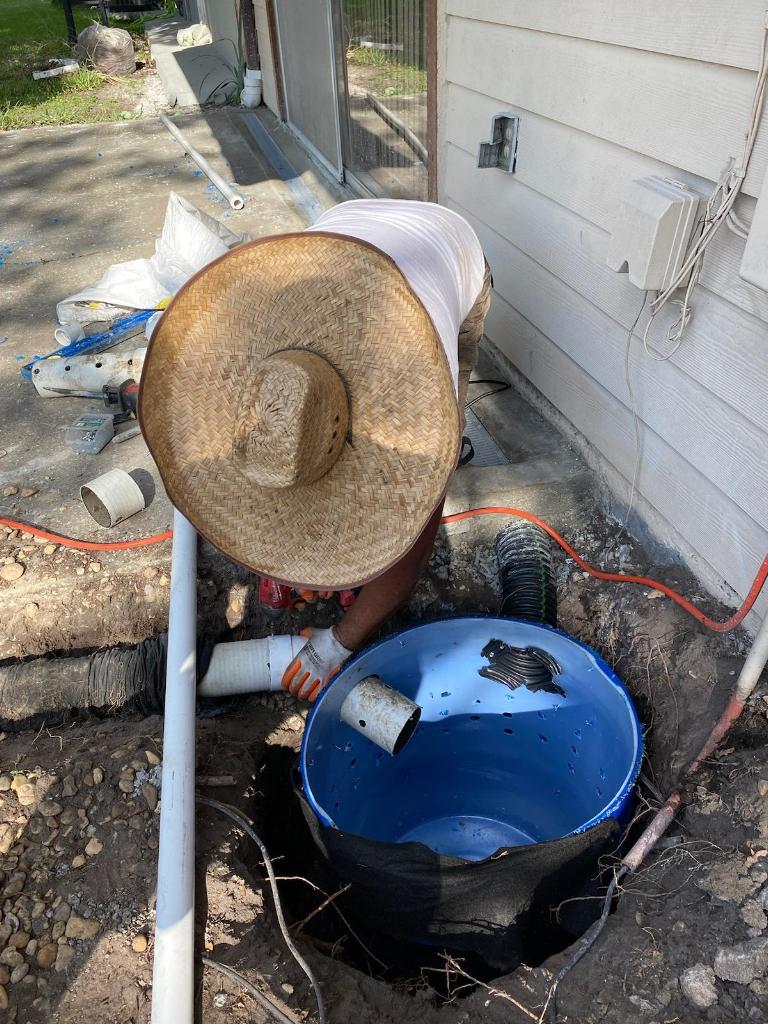 Team Member Installing Residential Sump Pump